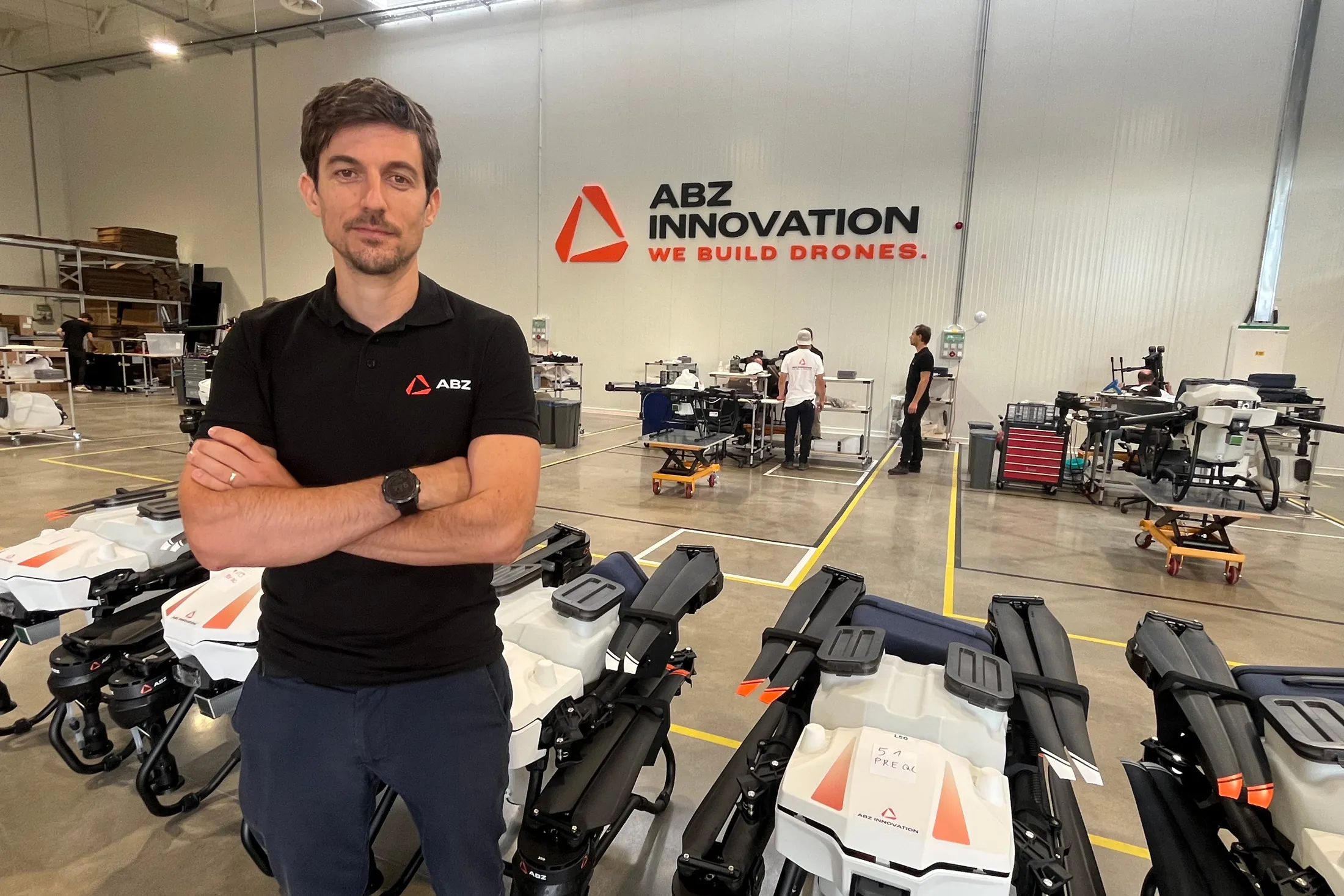 Engineers assembling civilian drones at a modern European manufacturing facility